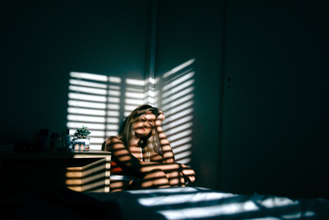 woman sitting on floor in dark