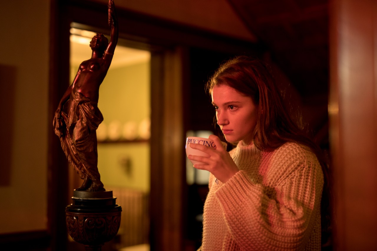 woman thinking while holding coffee cup