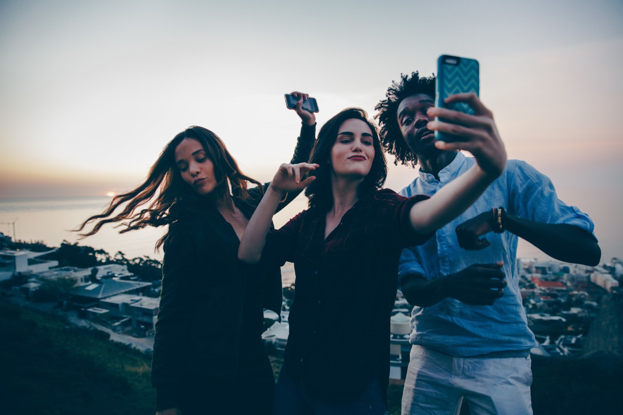 group of friends taking seflie being silly