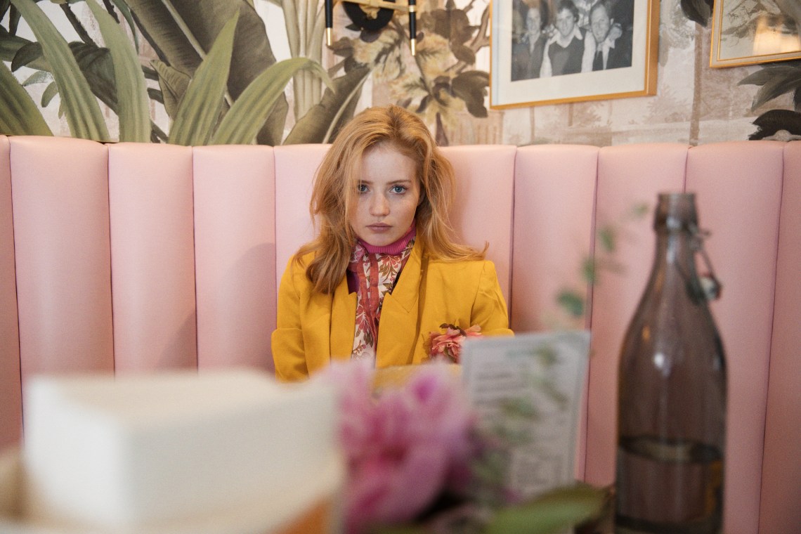 woman sitting at booth