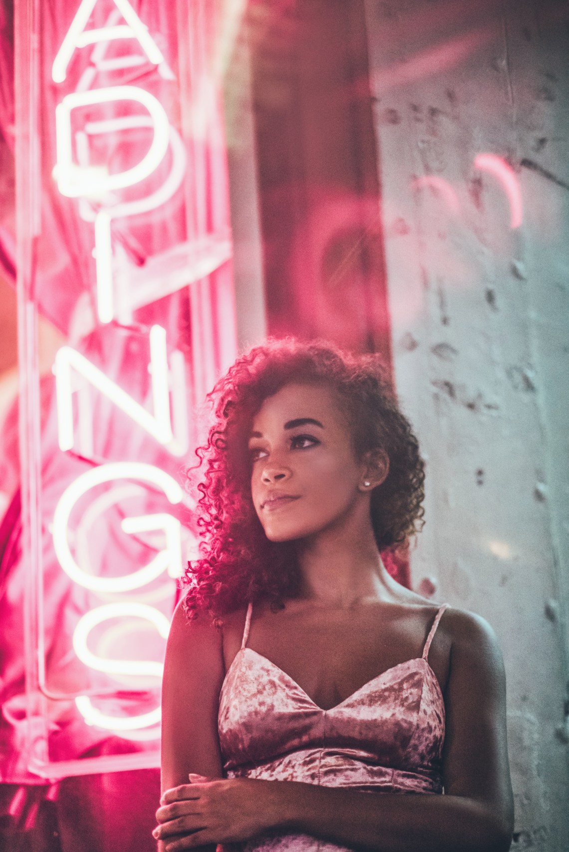 woman standing looking thoughtful