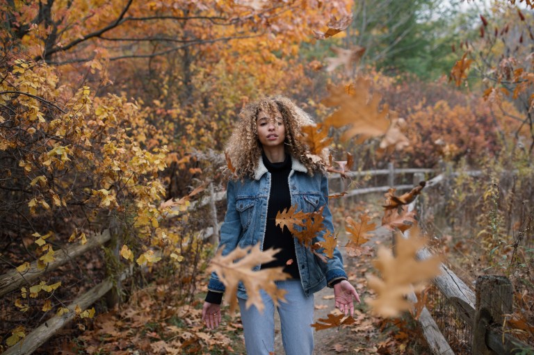 mysterious woman deems the falling leaves to stop