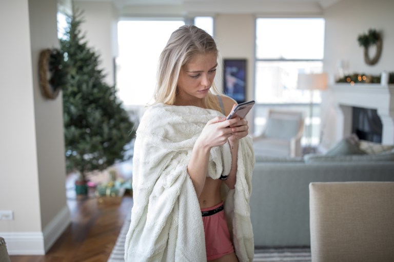 girl in pajamas looking at phone