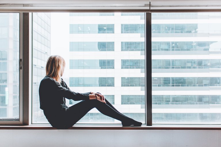 girl sitting in a window