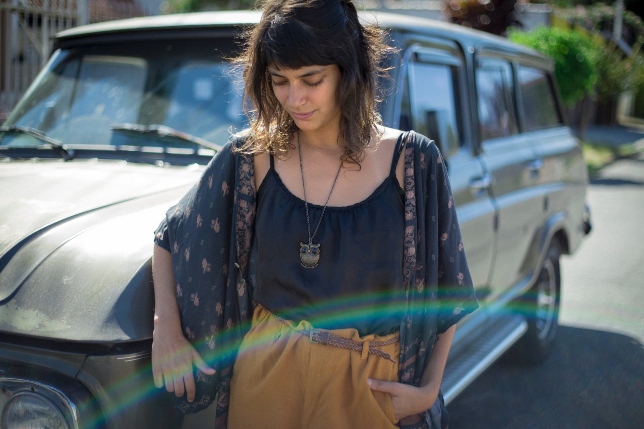 Woman standing in front of car