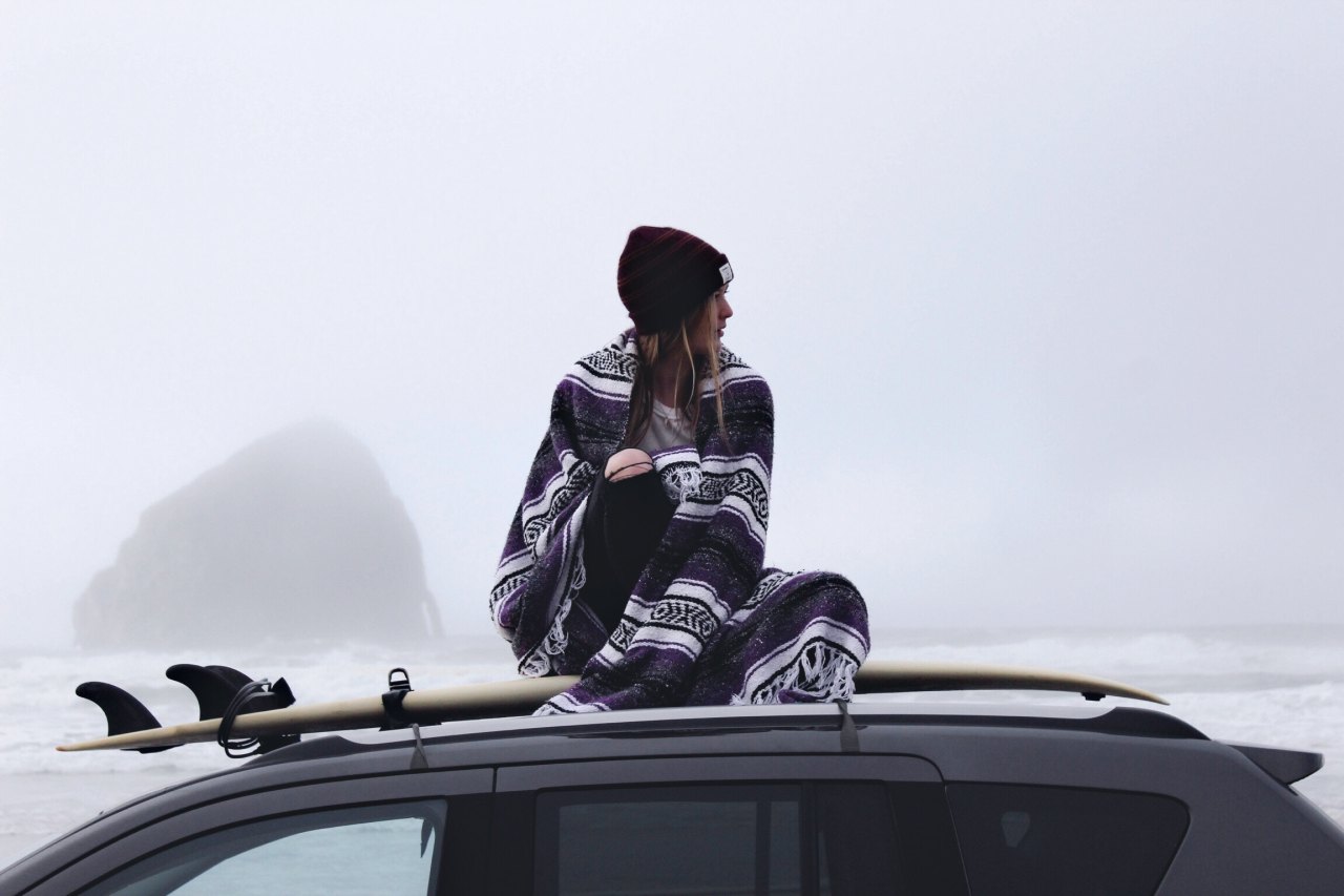 woman sitting on top of car