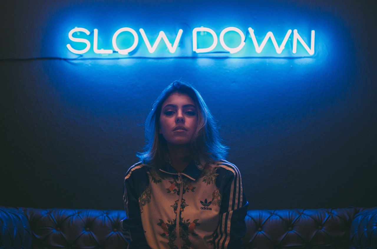 Woman standing under neon sign