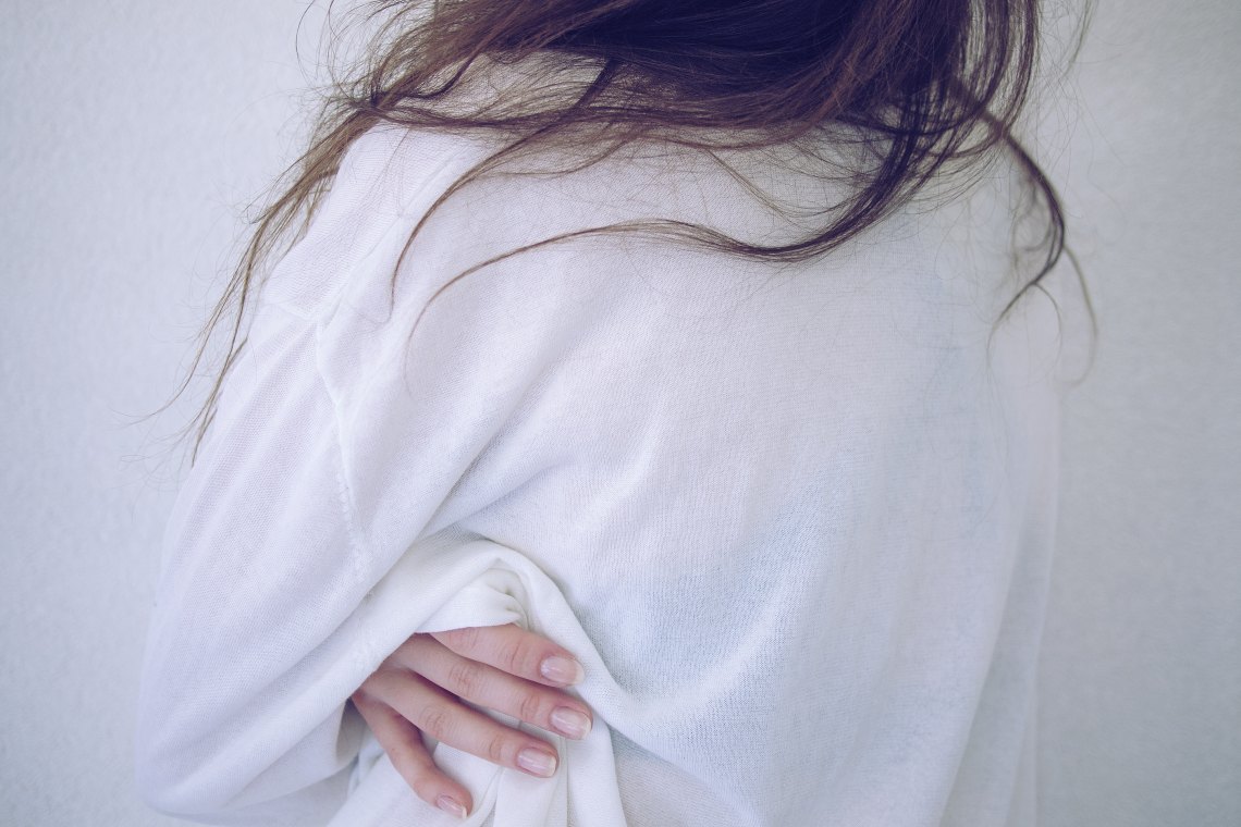 girl in a white sweater messy hair