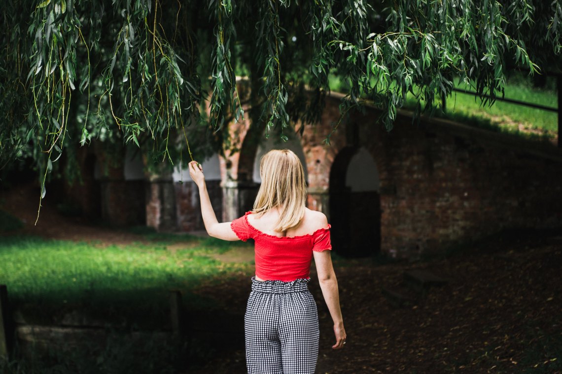 woman standing looking thoughtful