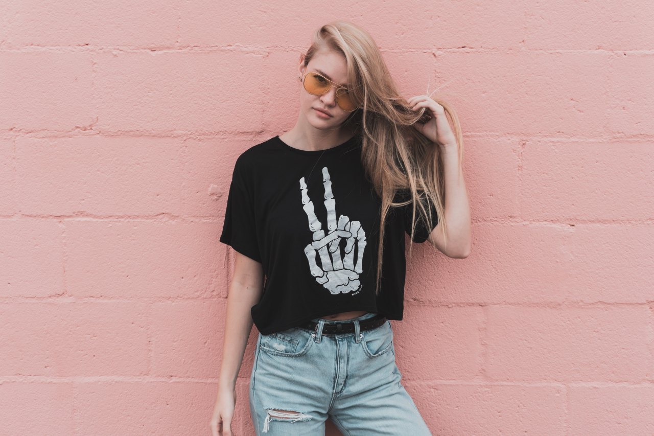 Girl standing in front of pink wall