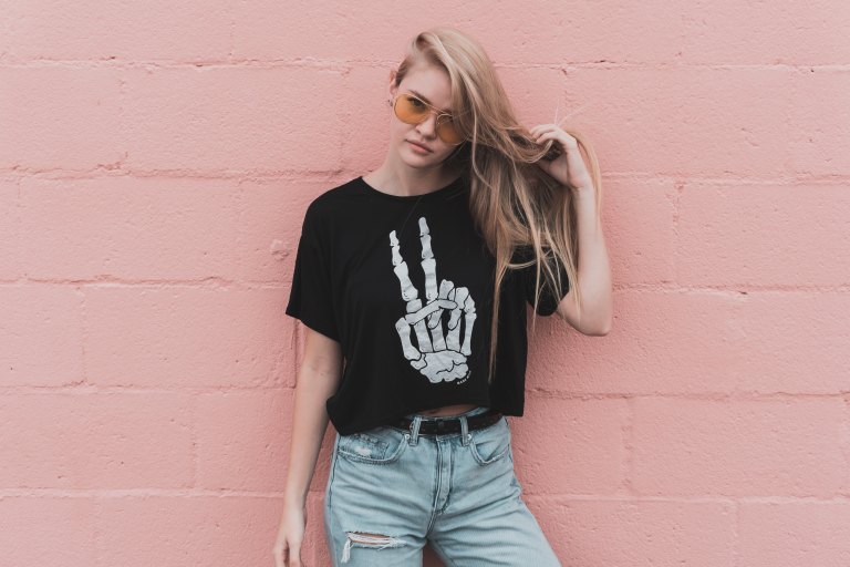 Girl standing in front of pink wall