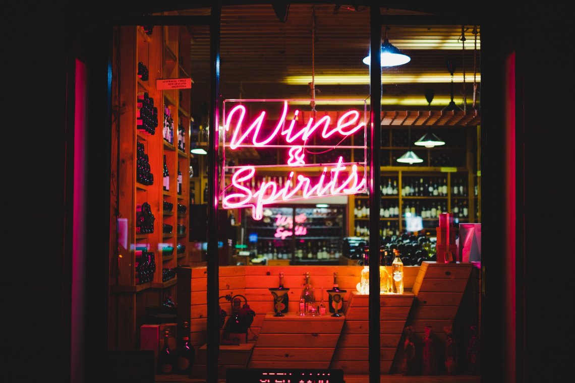 neon sign saying wine and spirits 