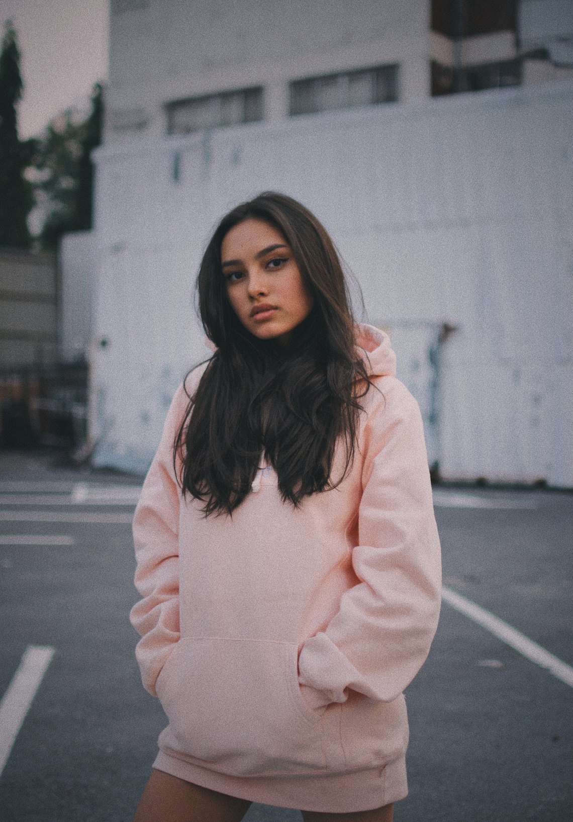 girl standing looking thoughtful