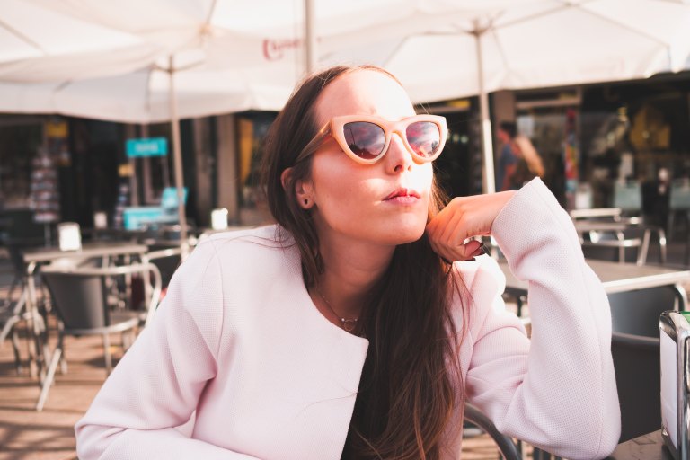 girl in a white jacket with sunglasses