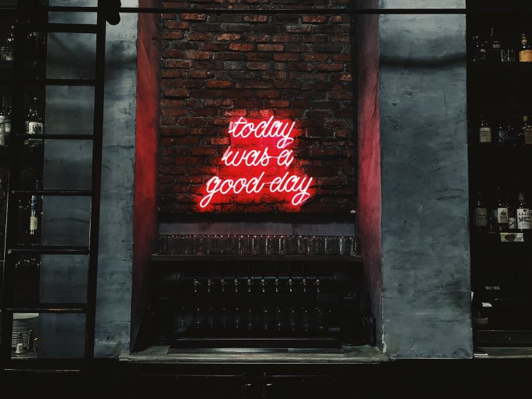 brick wall with neon sign