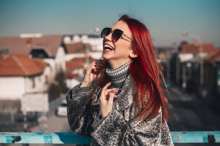 girl laughing in sunglasses