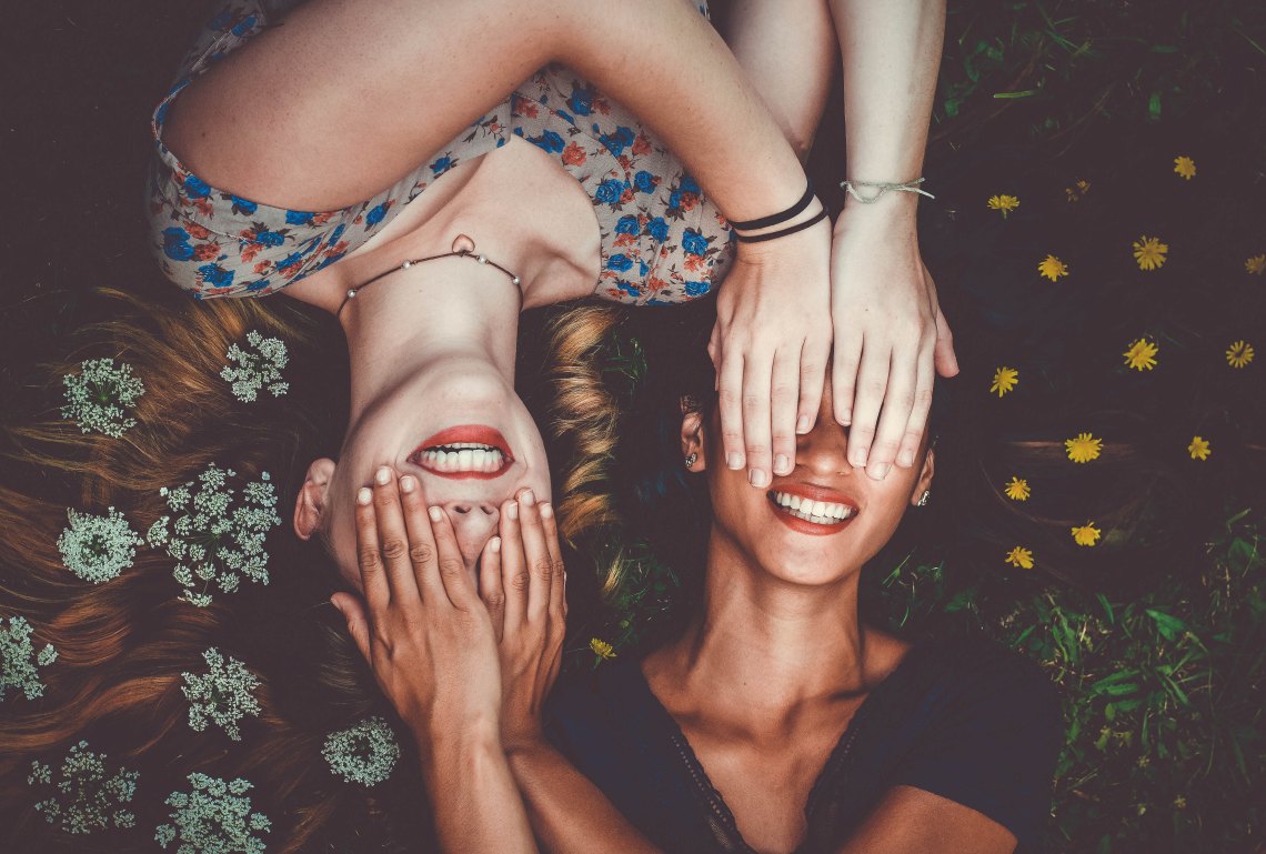 friends laying in flowers