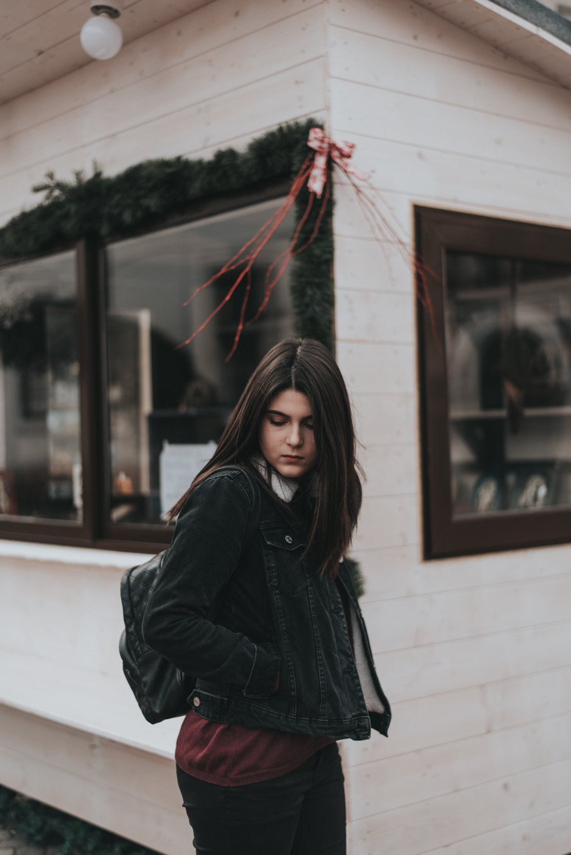 woman looking down standing outside