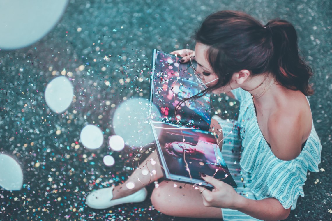 Girl looking at neon book