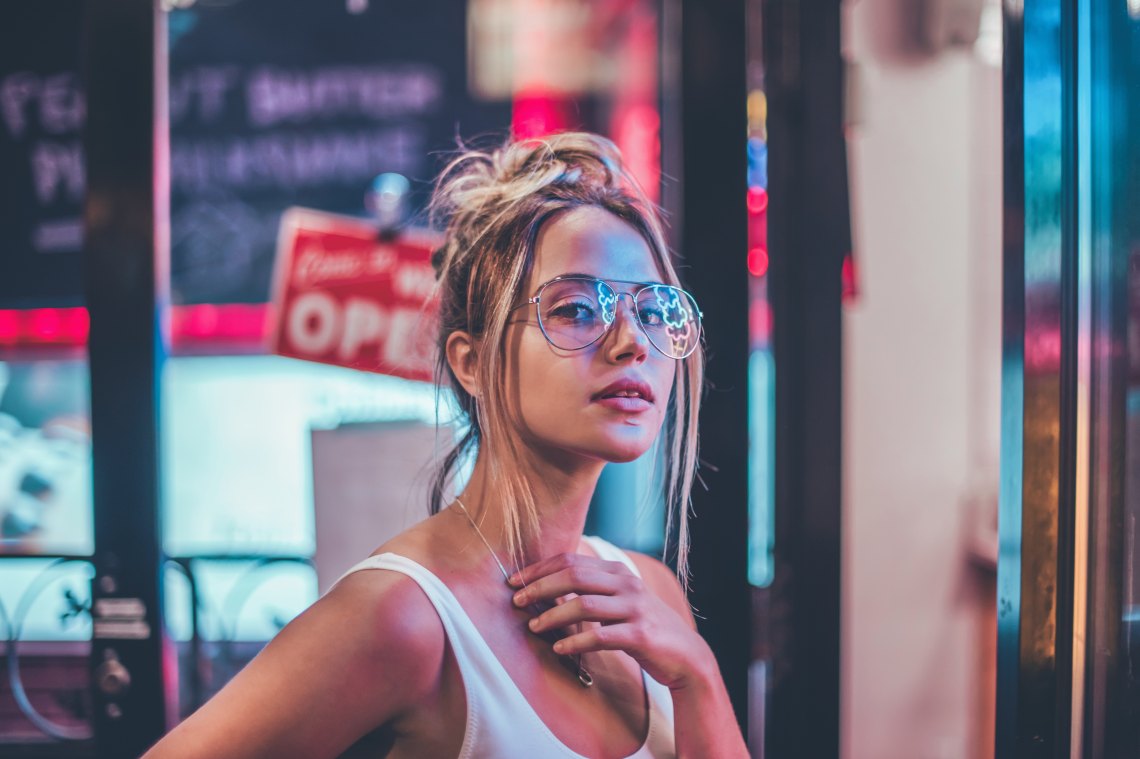 Woman standing in neon lights