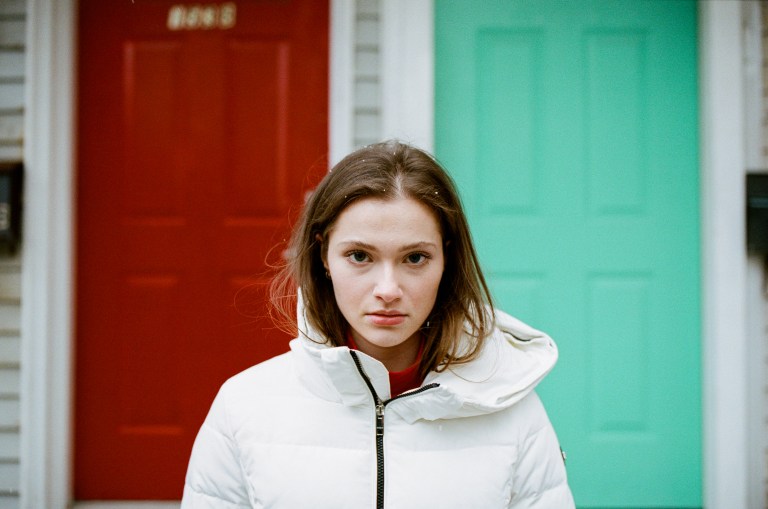 woman standing looking thoughtful