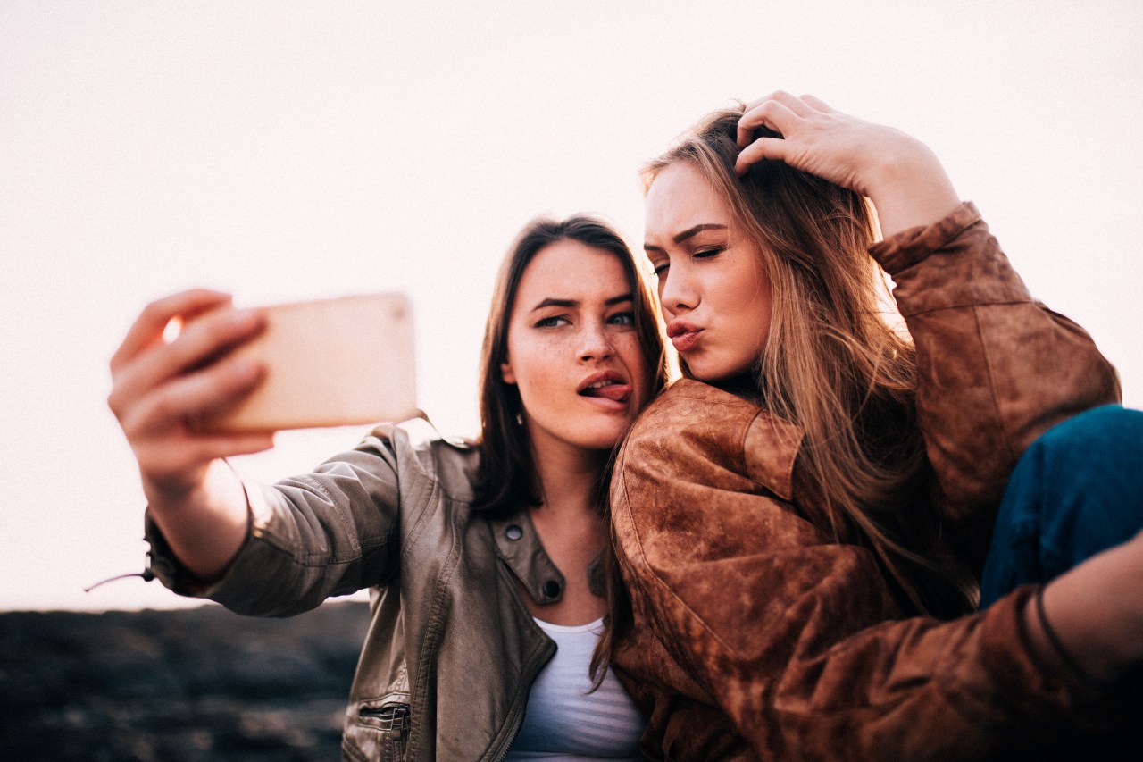 girl friends taking silly selfie