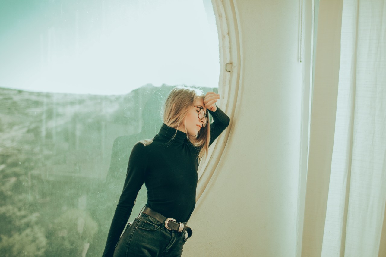 woman leaning by window