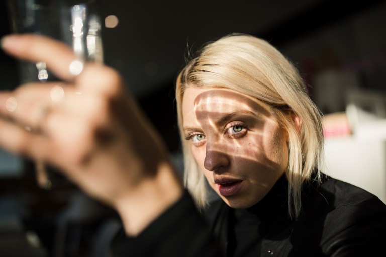 girl looking through a reflective glass