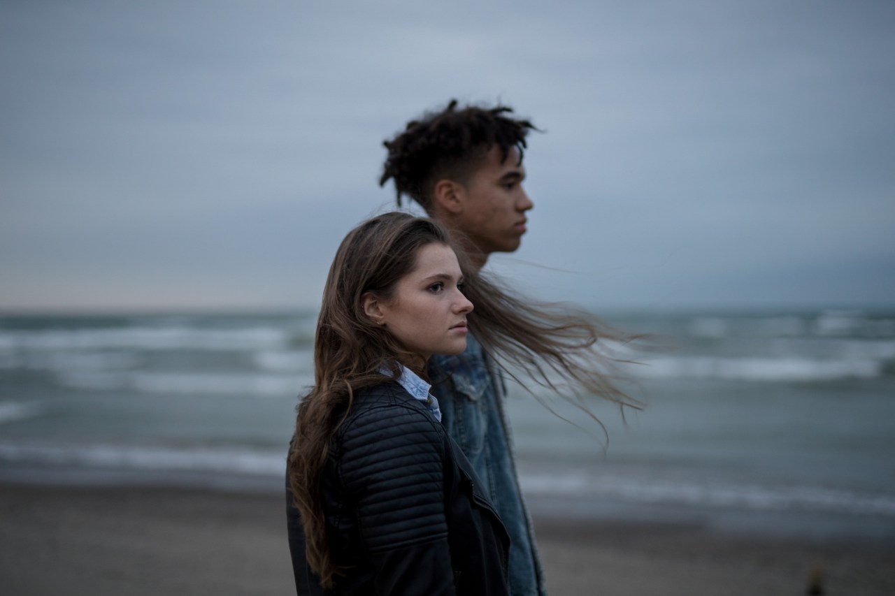 moody couple on the beach