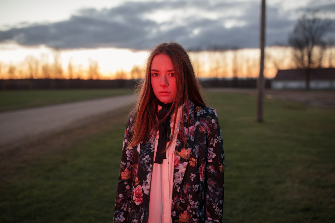 woman standing and thinking at dusk