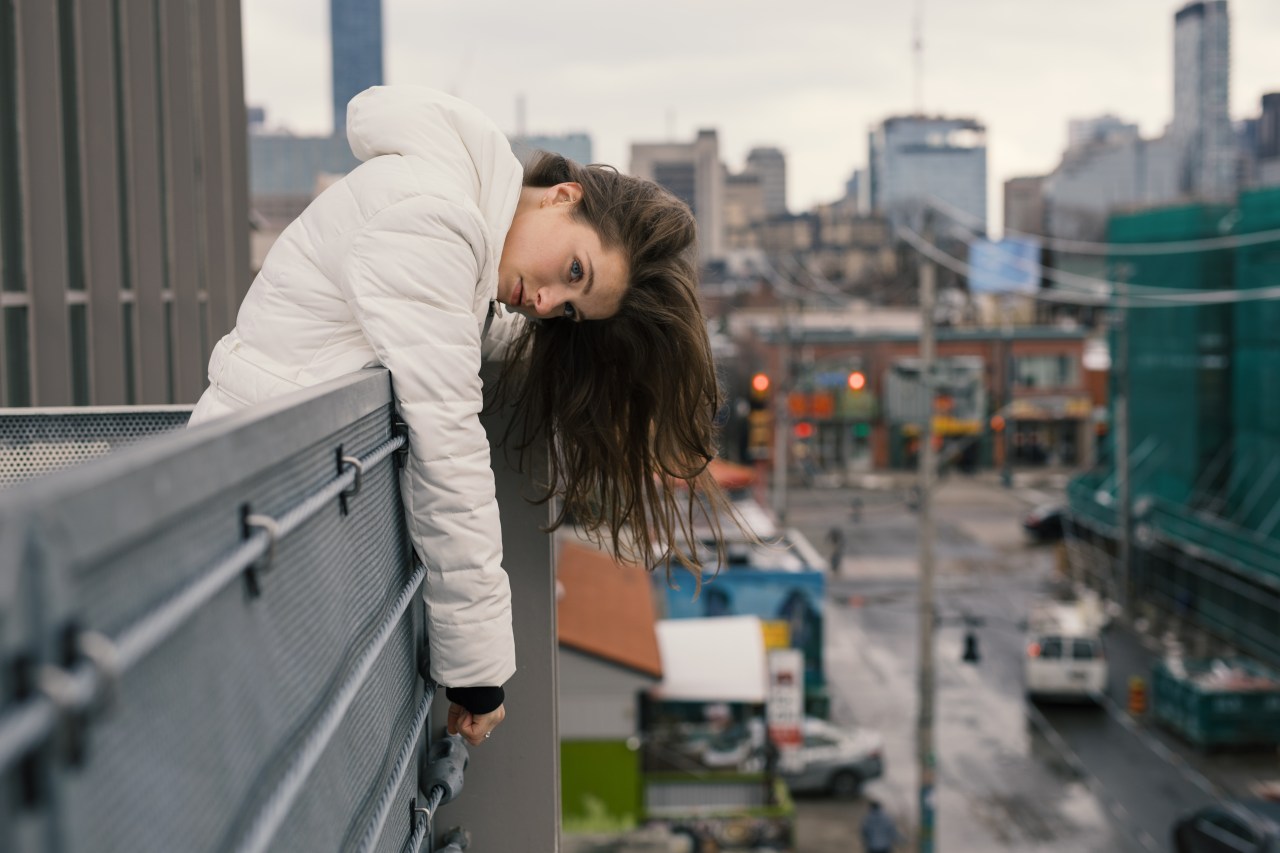 woman leaning over edge