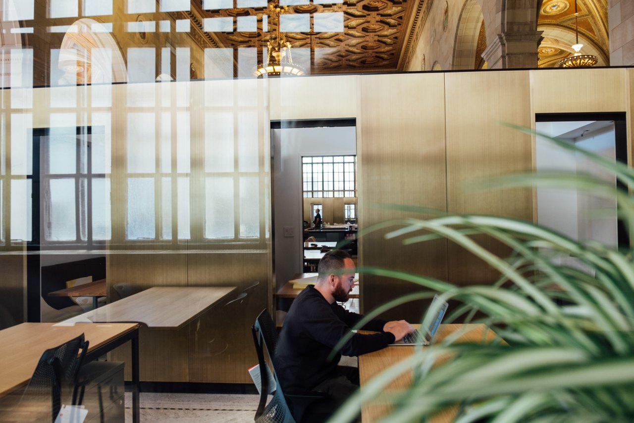 Man working in bright cafe