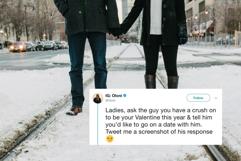 A couple holds hands on a snowy street