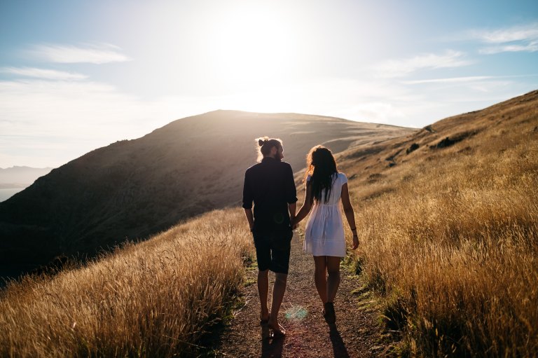 couple walking through field