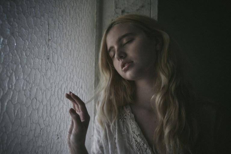 woman next to a window