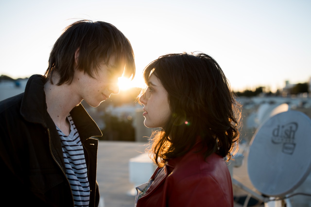 couple standing at sunset gazing into each other's eyes