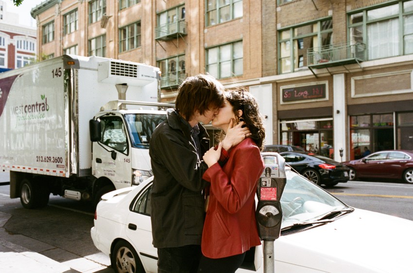 couple making out on sidewalk