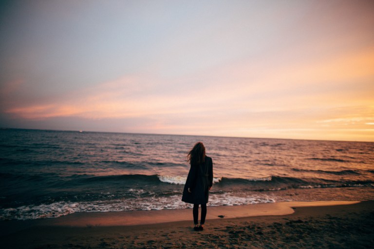 girl standing by the coast