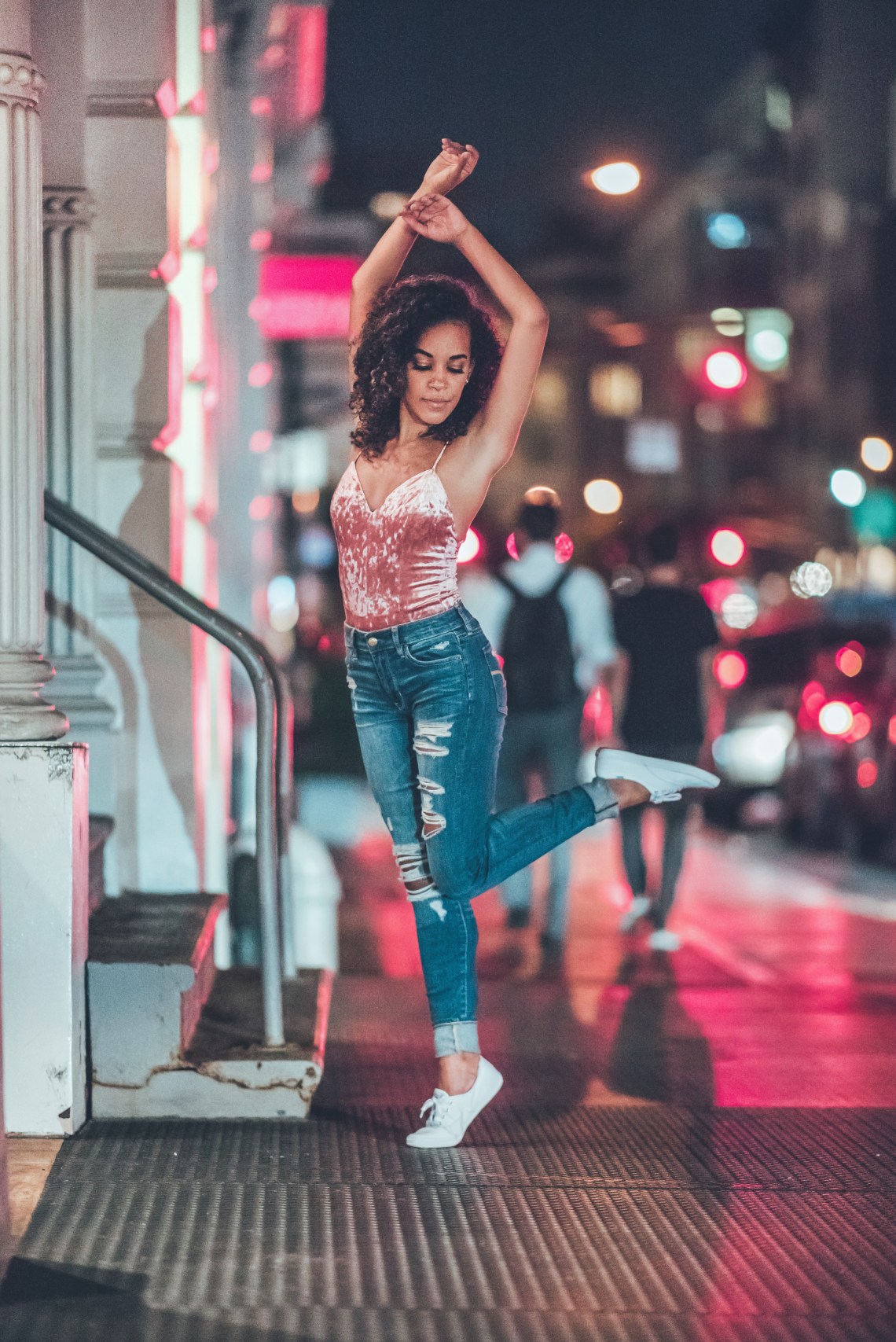 woman dancing on street at night