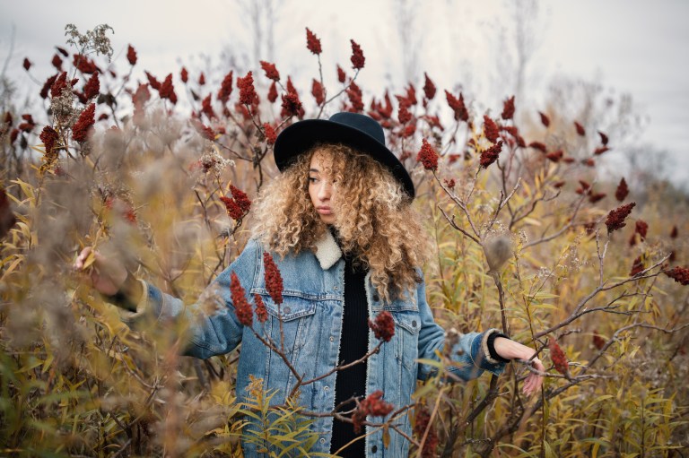 Lovely Lady Captivated by the Magnificence of Red Flowers