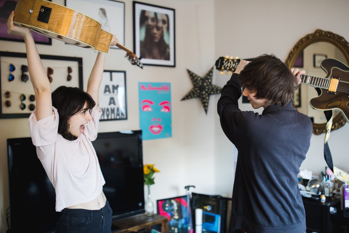 couple playing with guitars