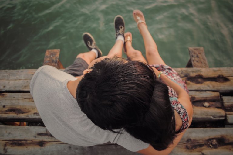 couple cuddling on dock