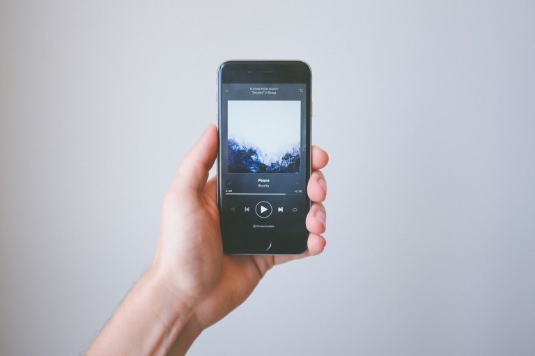 a photo of a phone with a spotify playlist