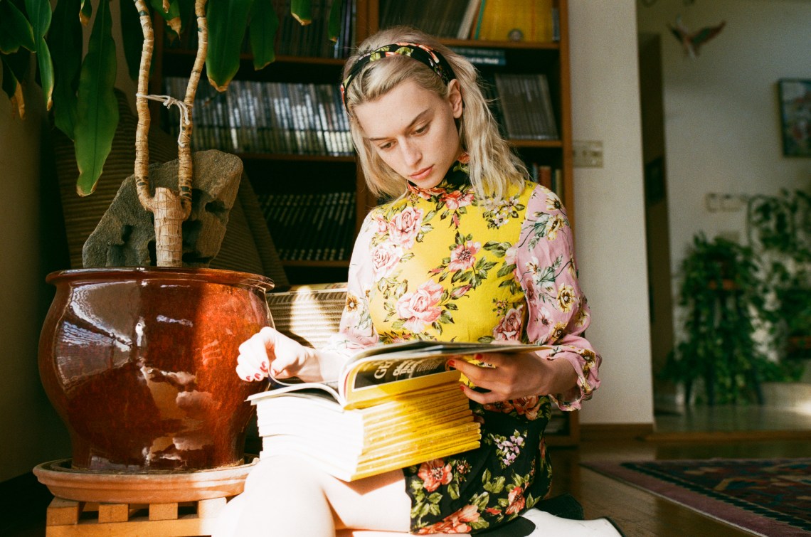 woman reading a ton of magazines