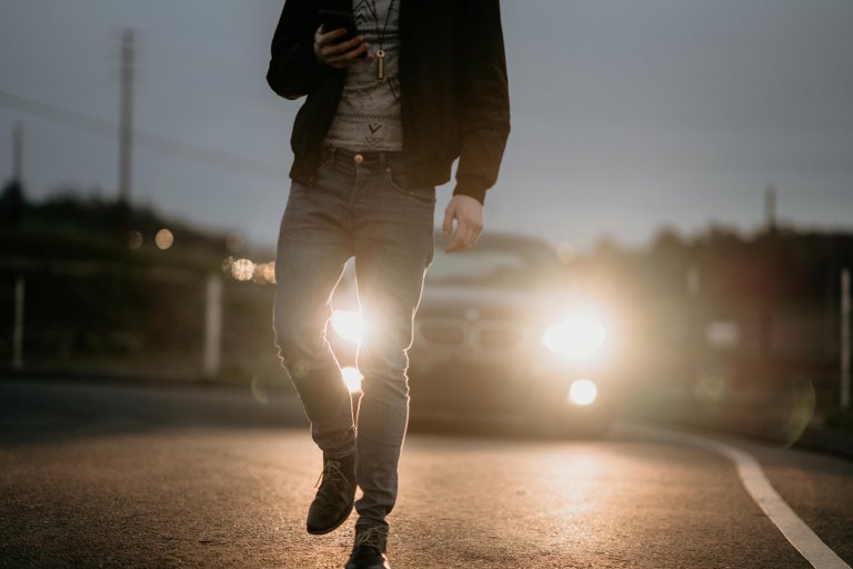 man walking along road