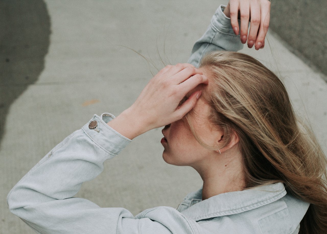 woman in jean shirt stretching