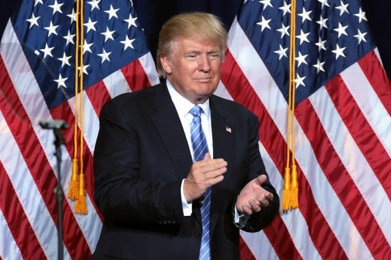 Trump claps during one of his rallies