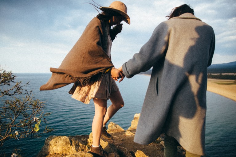 couple holding hands on beach