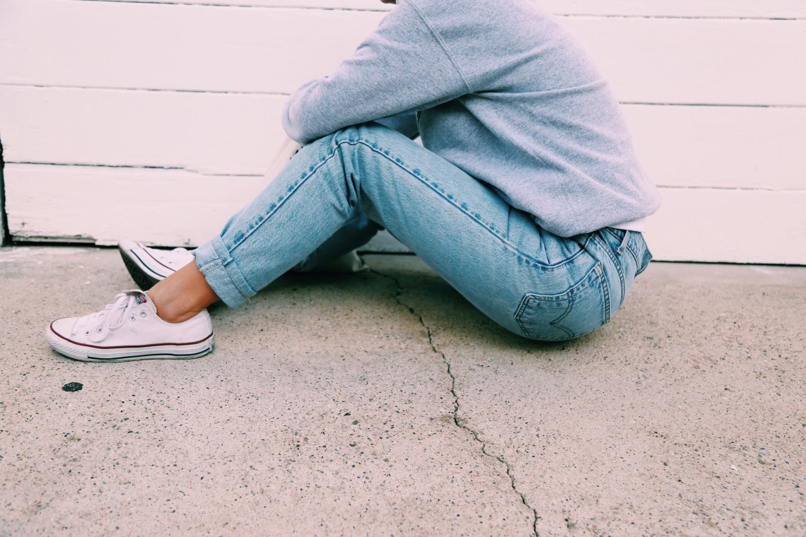 woman in jeans sitting 