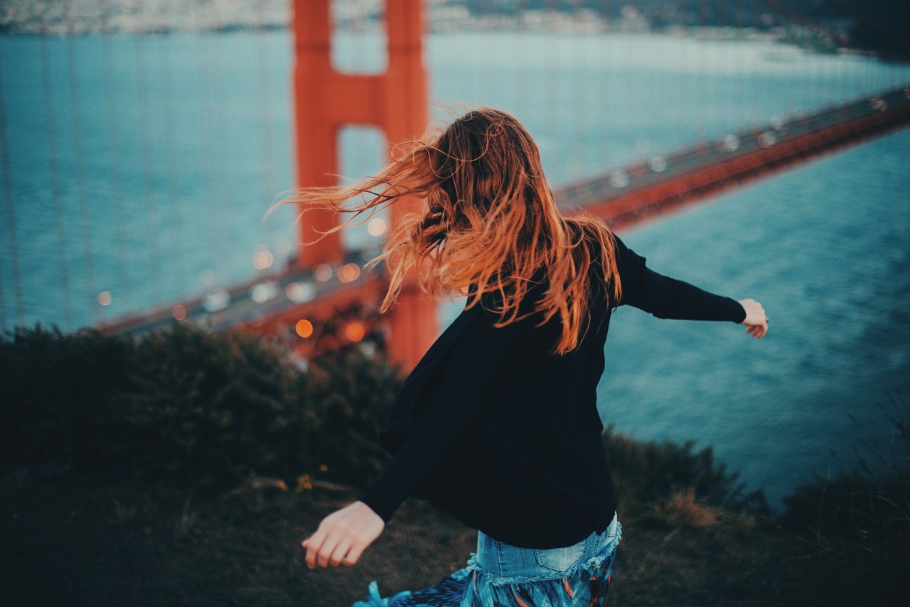 woman looking carefree by golden gate bridge